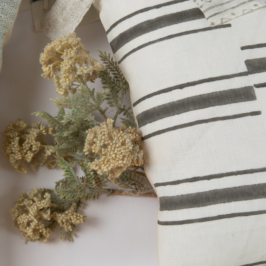 Beni Gray on White Pillow