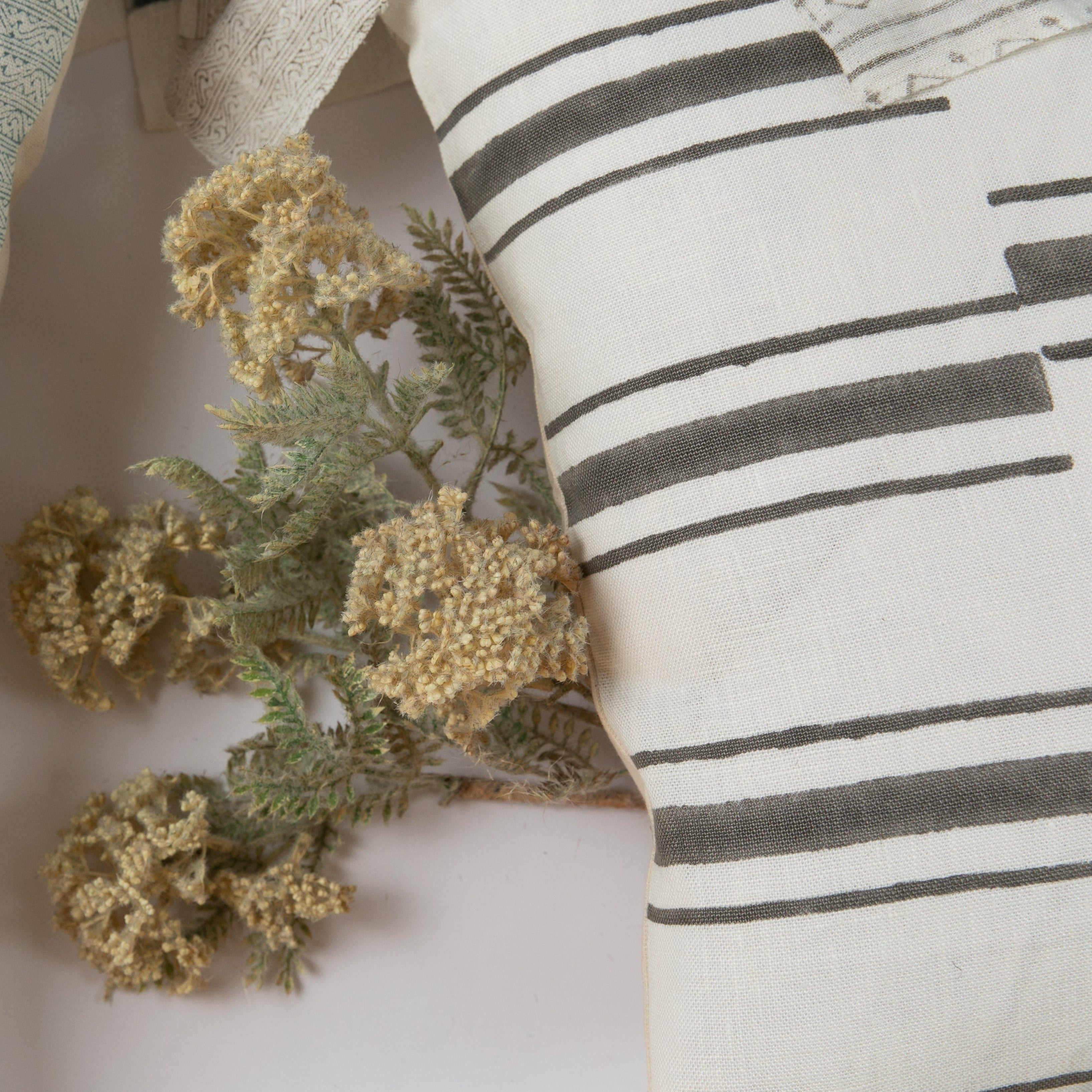 Beni Gray on White Pillow