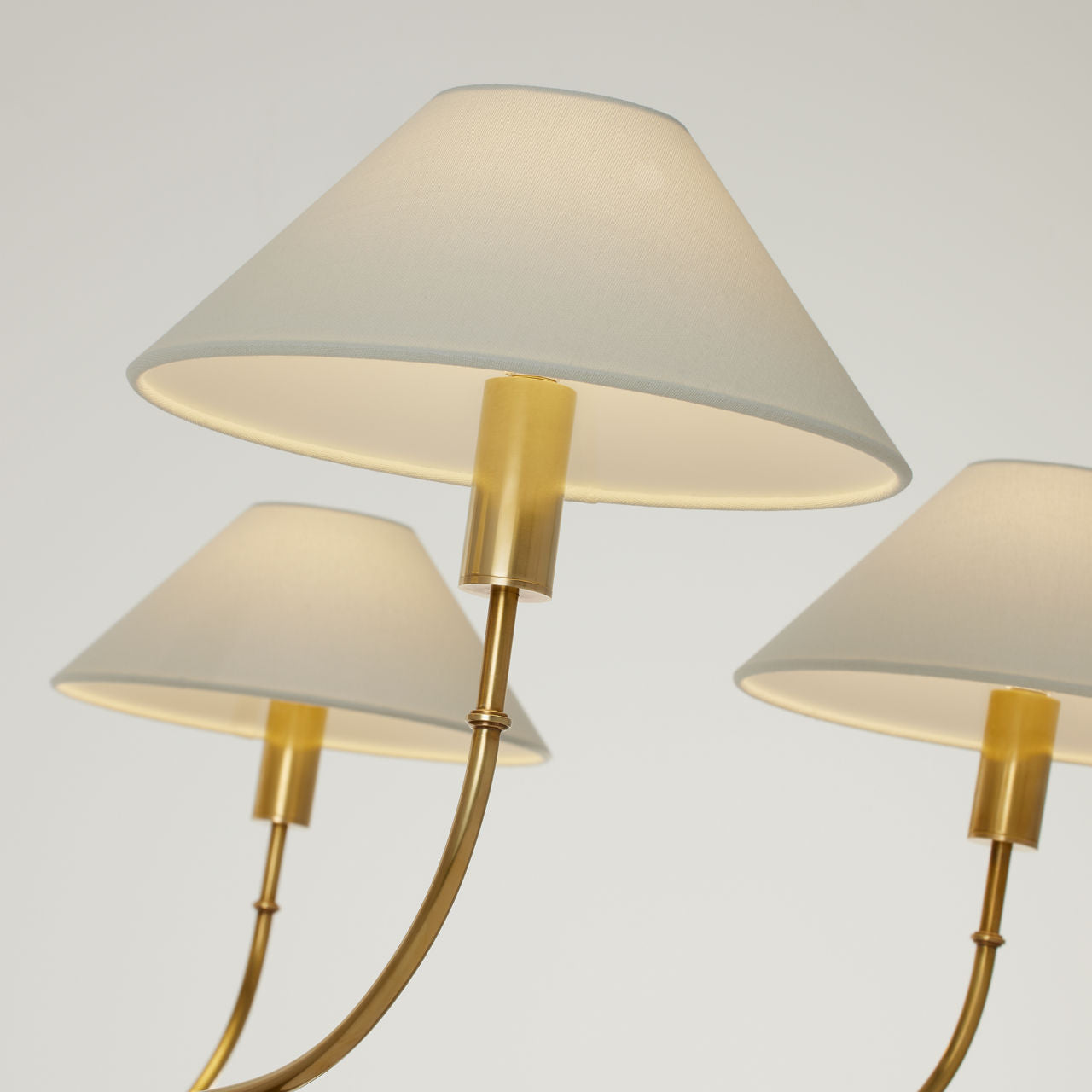 Griffin Grande Tail Chandelier | Hand-Rubbed Antique Brass and Saddle Leather | Linen Shades